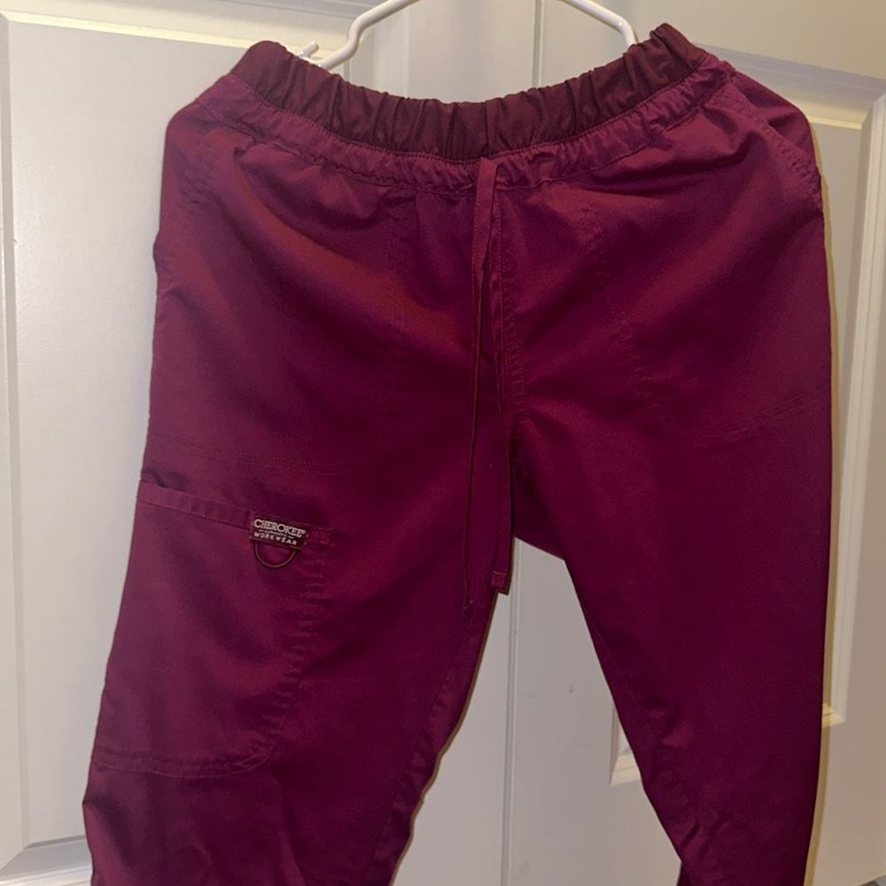 Burgundy scrub pants.